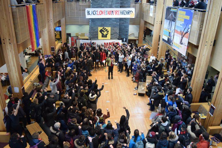 Marchers raised their fists in solidarity at the end of the “March for the Damned” last Thursday, circling Isaiah Blake ’21 in Baxter Hall.
SABRINE BRISMEUR/PHOTO EDITOR