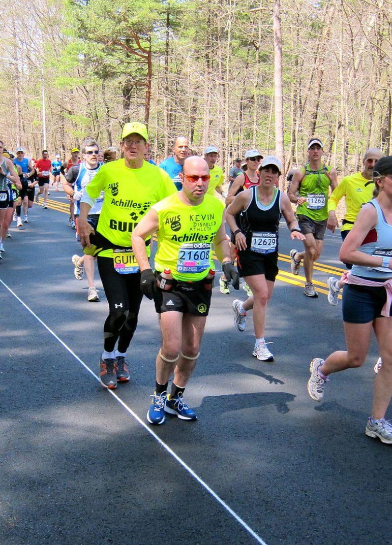 Art, left, guided Kevin Counihan in the Boston Marathon in 2011. Photo courtesy of Wikimedia Commons.