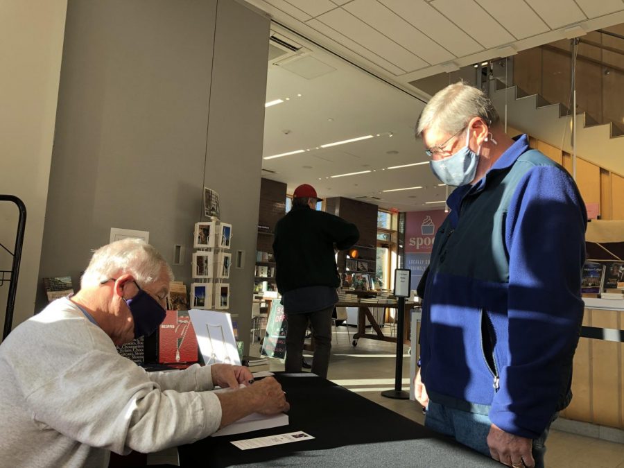 Farley signs a copy of the book for Williamstown resident Roger St. Pierre, who long hosted the traditional Homecoming Walk at his barber shop. (Photos courtesy of Sports Information and Dick Quinn.)	