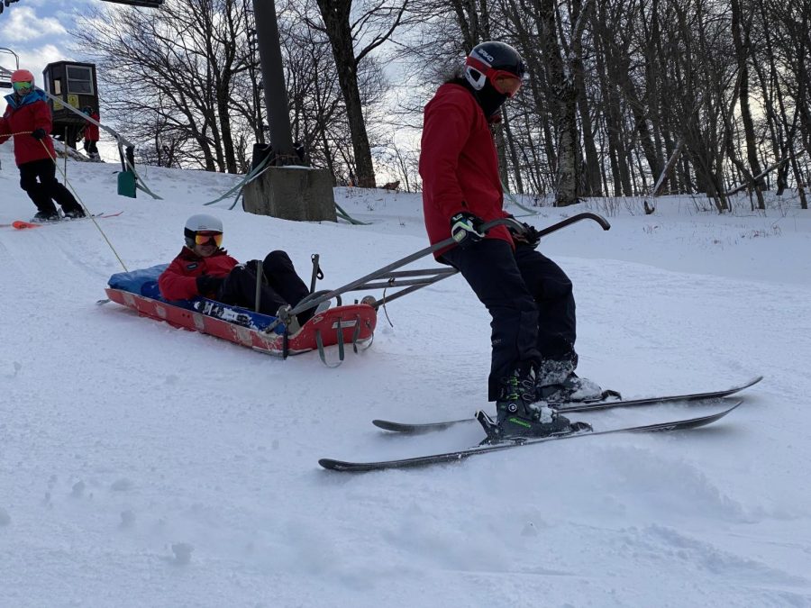Student ski patrollers practice patient transportation at Jiminy Peak.  (Photo courtesy of Lizzie High.)