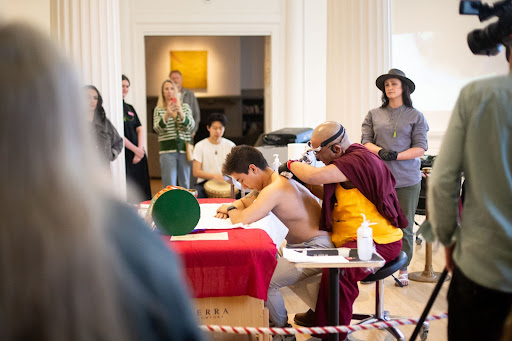 ‘Don’t let us become art in a museum’:  WCMA celebrates Tibetan, Indigenous cultures through tattoo performance art