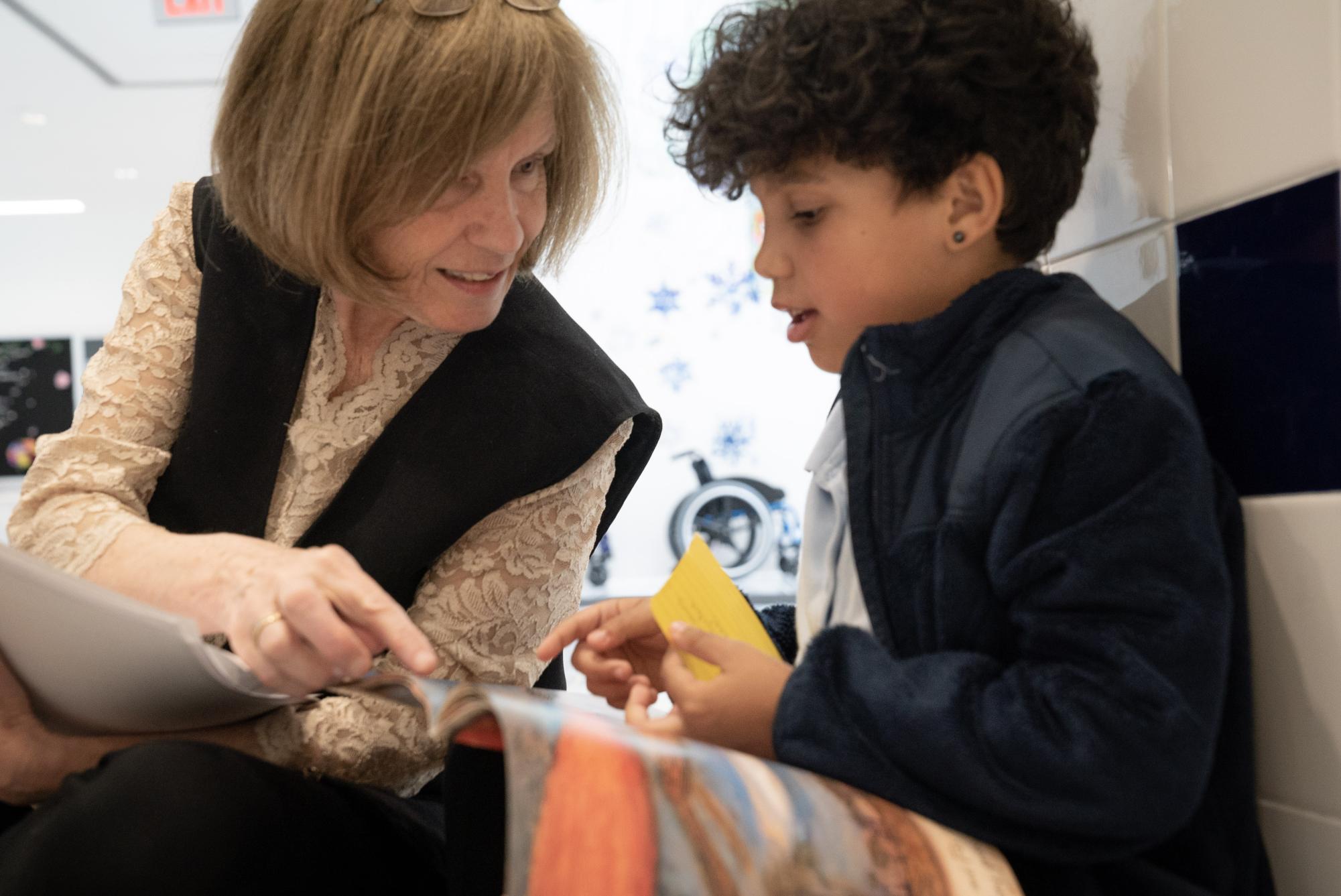 Lucy Calkins works with an elementary-school student learning to read using her Units of Study curriculum. (Photo courtesy of Lucy Calkins.)