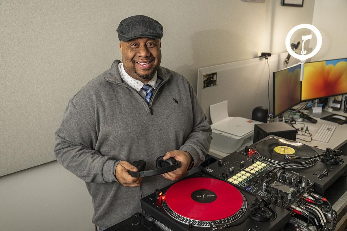 J. Rawls poses with his turntables and mixer. (Photo courtesy of J. Rawls.)