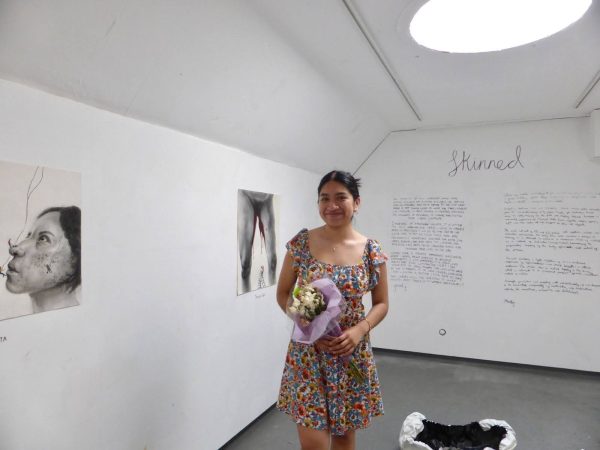 Gissel Gomez poses in front of her artwork. (Photo courtesy of Gissel Gomez.)