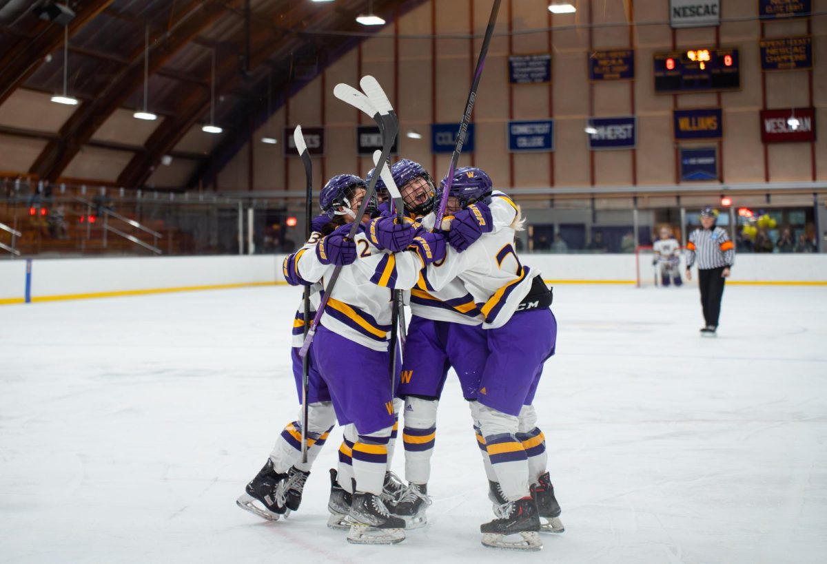 The women’s ice hockey team celebrates their weekend sweep against Colby College. (Photo courtesy of Maya Singh.)